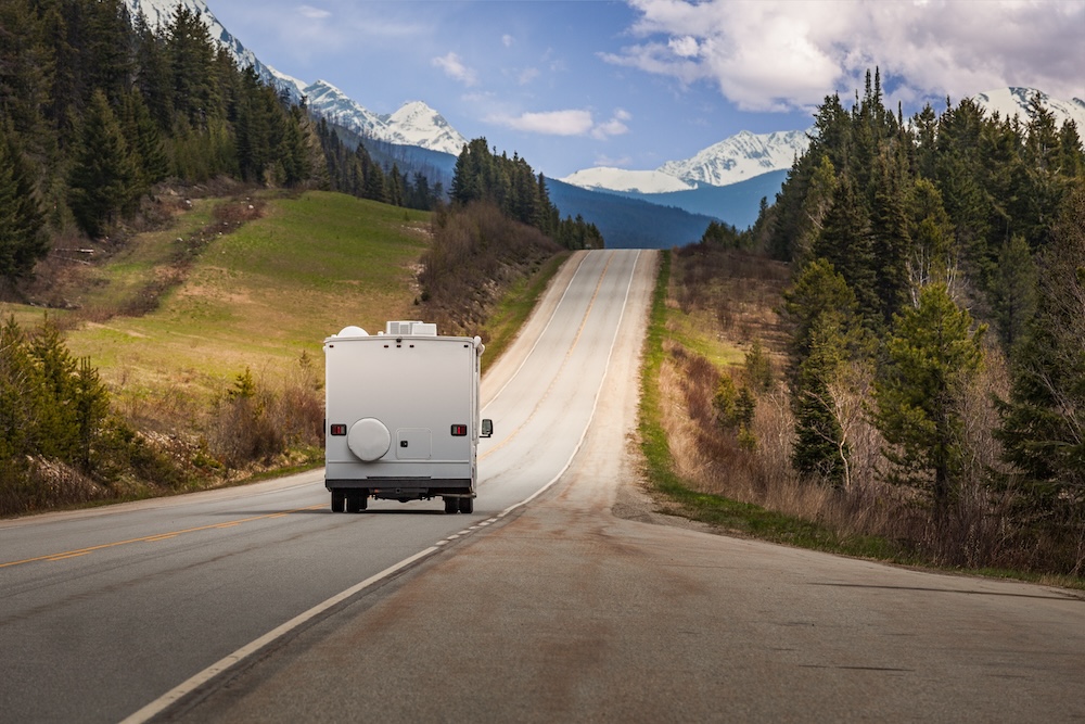 An RV rolls down a winding mountain road