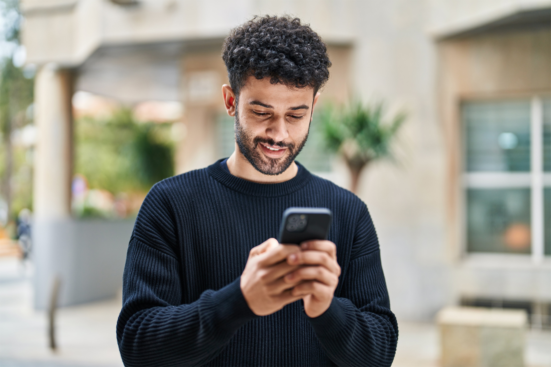 A man managing his Debit Card using a mobile banking app.