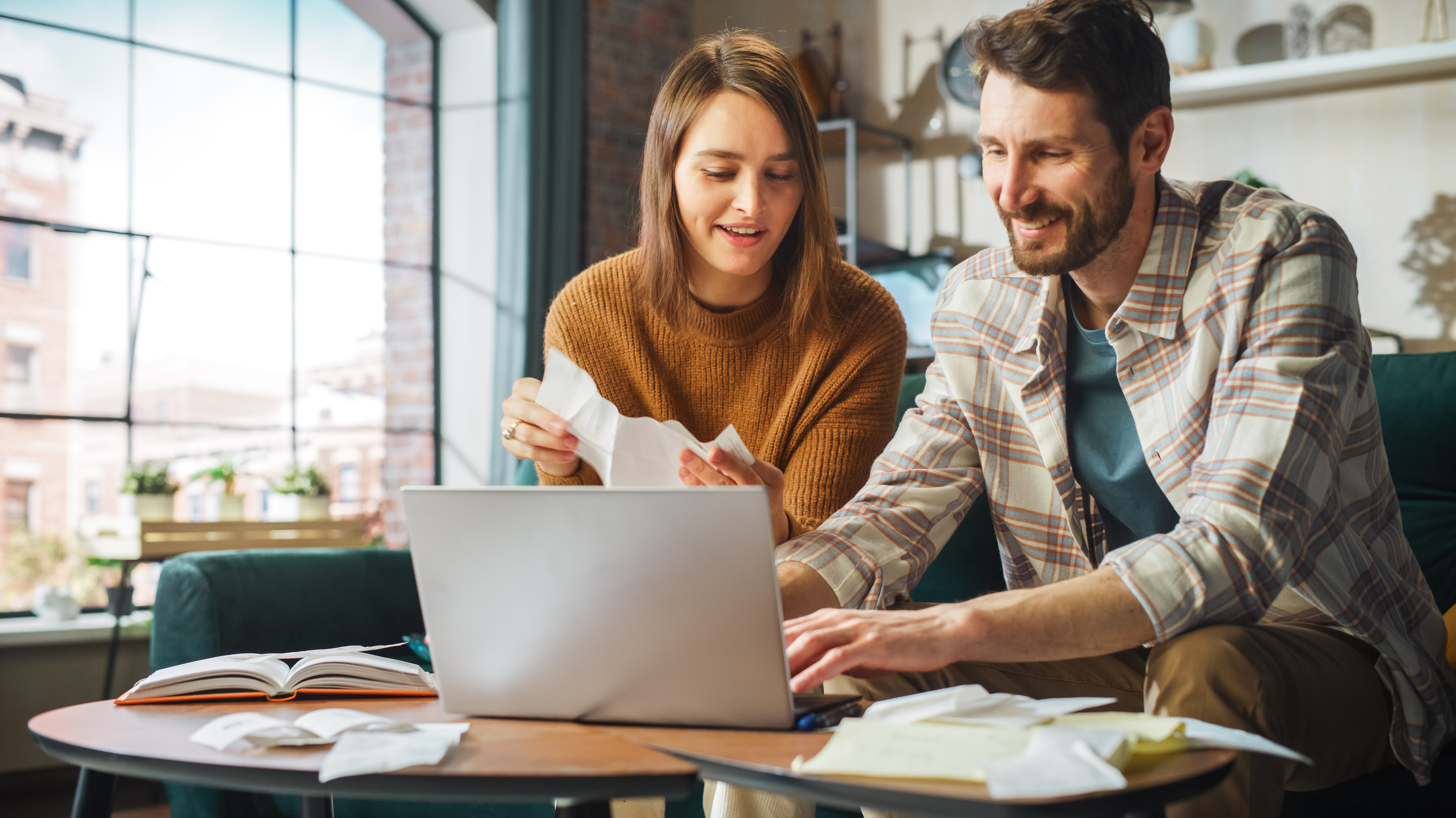 A couple works out a budget using financial education resources.