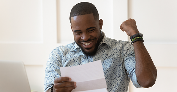 A man is happy to be approved for a personal loan.