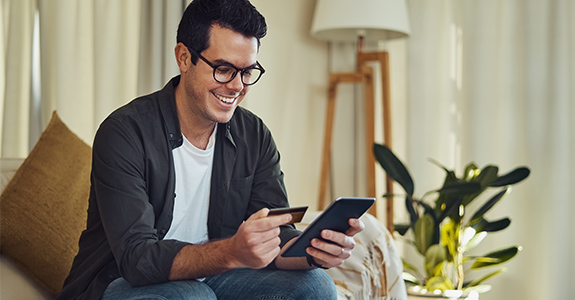 A man checks his credit score after making payments on a share secured loan.