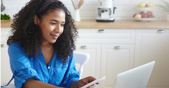 A woman signing loan documents from her home using DocuSign®.